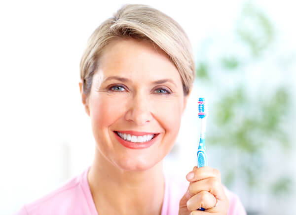 Beautiful mature woman with a toothbrush.  Dental health