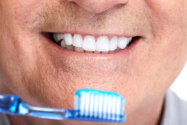 Handsome smiling mature man teeth with toothbrush