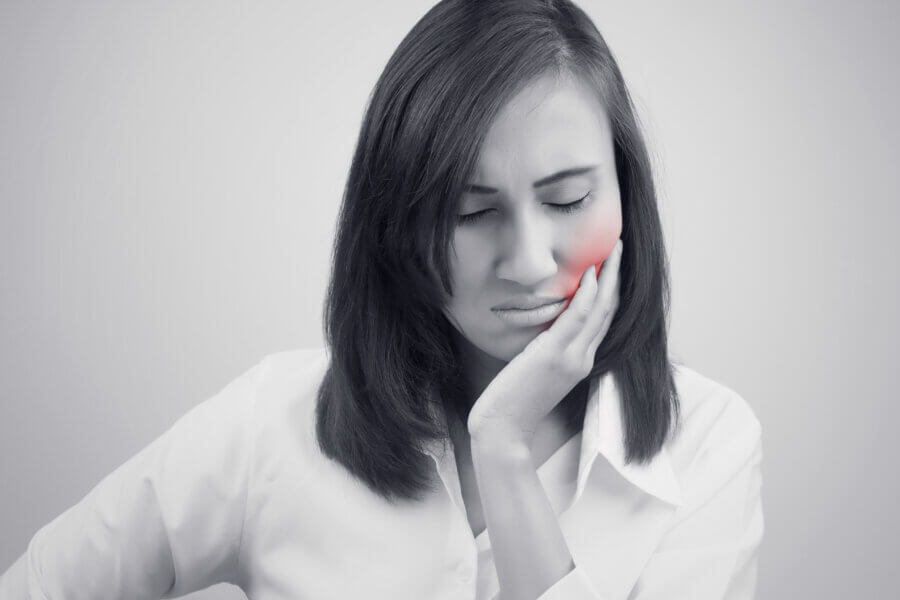 Woman with gum and tooth pain due to periodontal disease. 