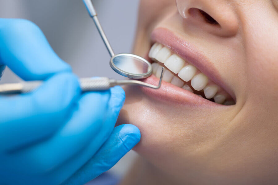 Girl with beautiful white teeth on reception at the doctor dentist getting dental cleaning