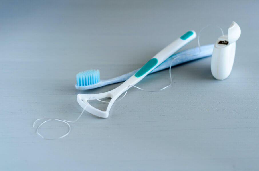 Oral hygiene health concept. Closeup dental tools toothbrush, dental floss and tongue cleaner.
tongue cleaning