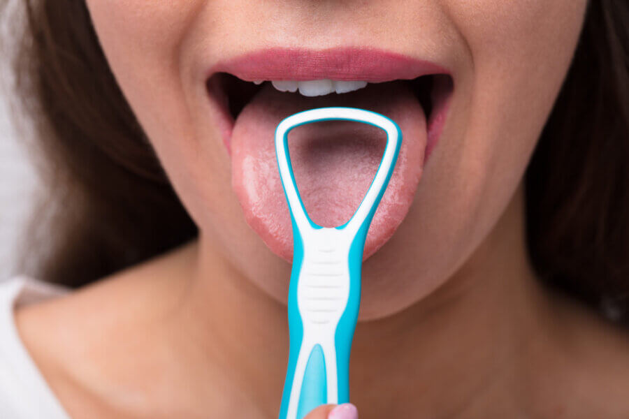 clean your tongue Close-up Of A Woman Cleaning Her Tongue With Cleaner